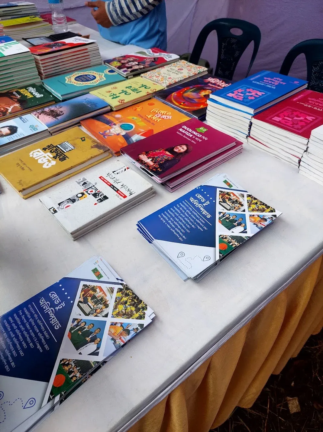 BdOSN stall with Road to Olympiad brochures, Mymensingh 2025